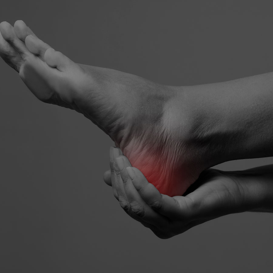 Picture of person holding their heel with heel pain, peripheral neuropathy