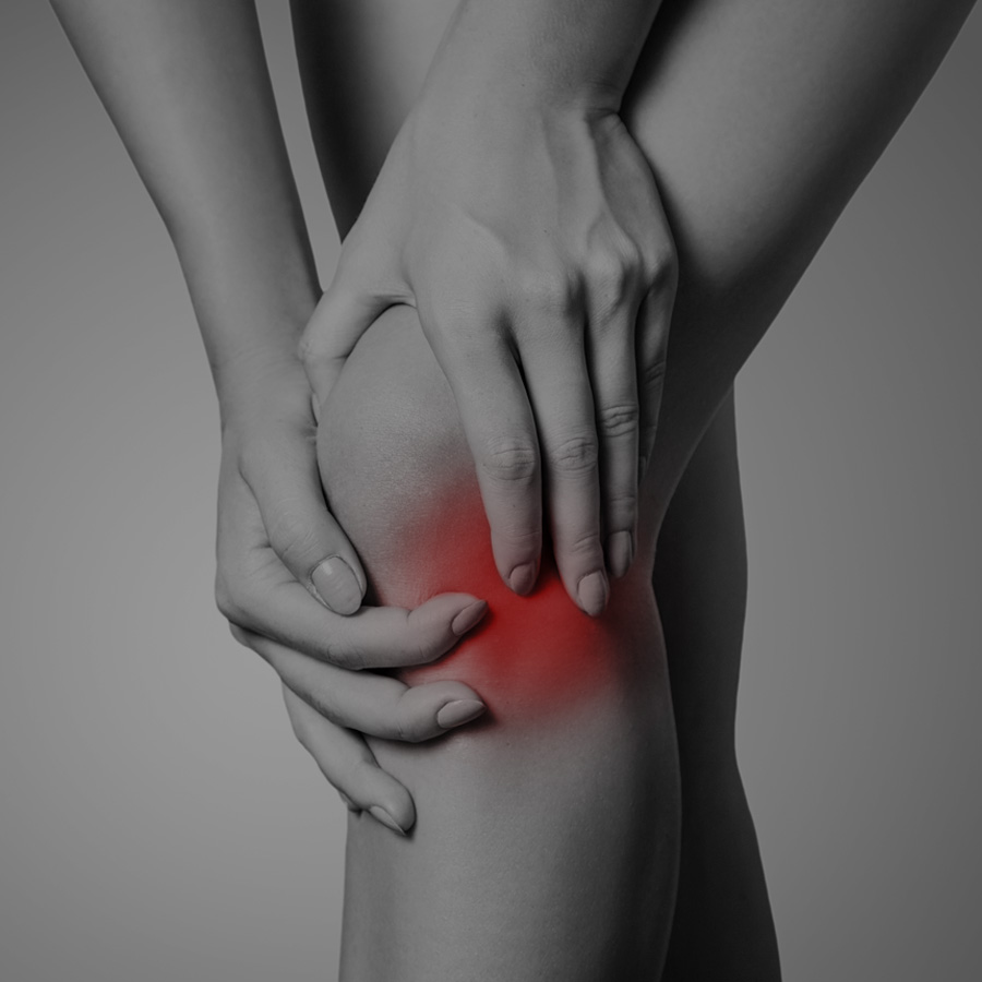 Picture of woman holding her knee with knee pain